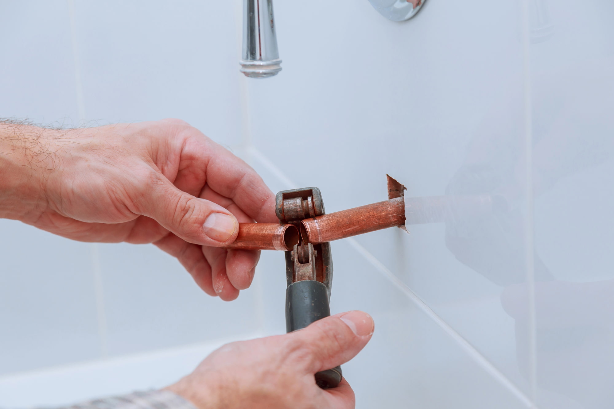 Plumber repairing copper pipe