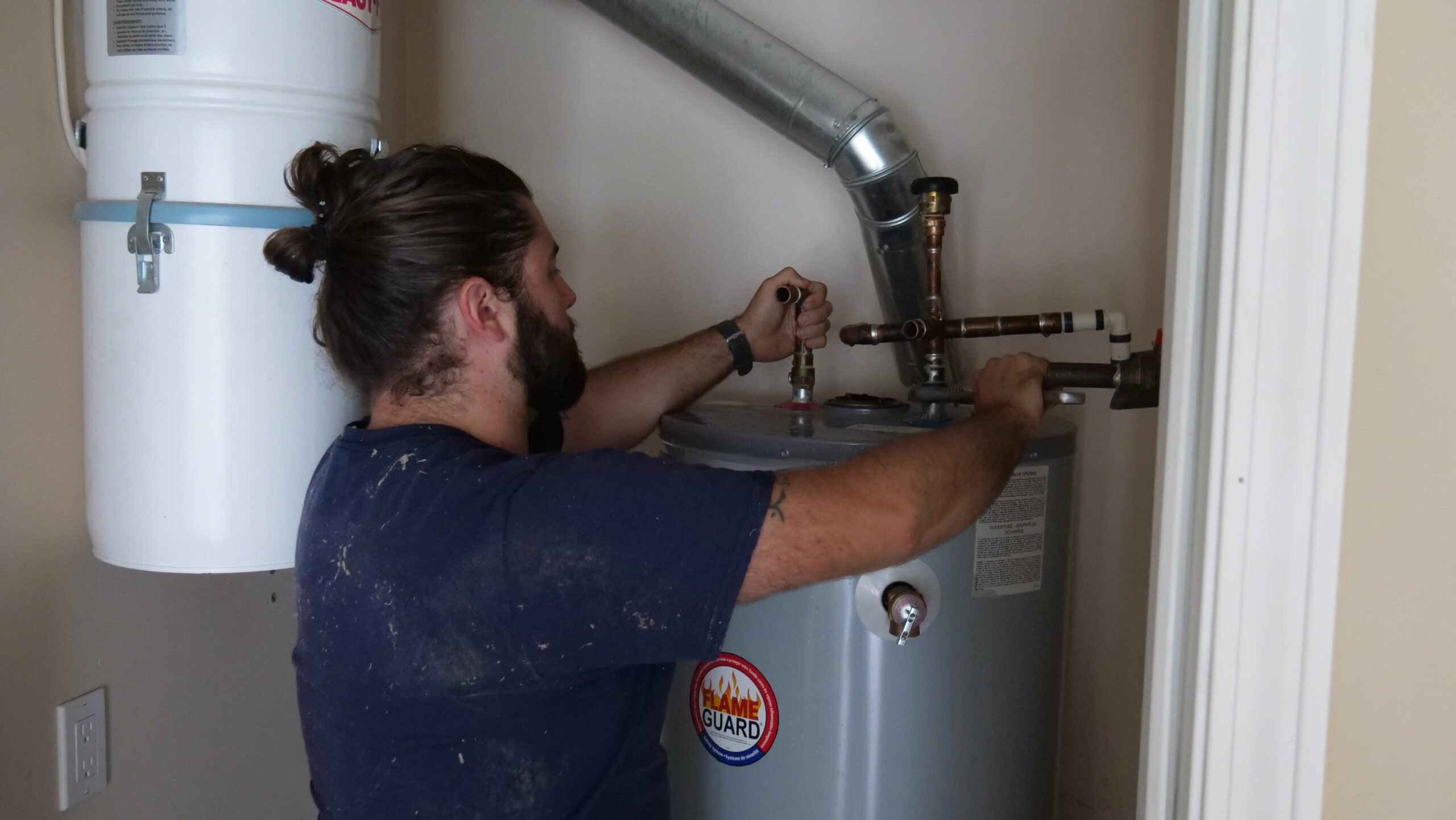 Clayton Bristow repairing residential water heater at a customers home.