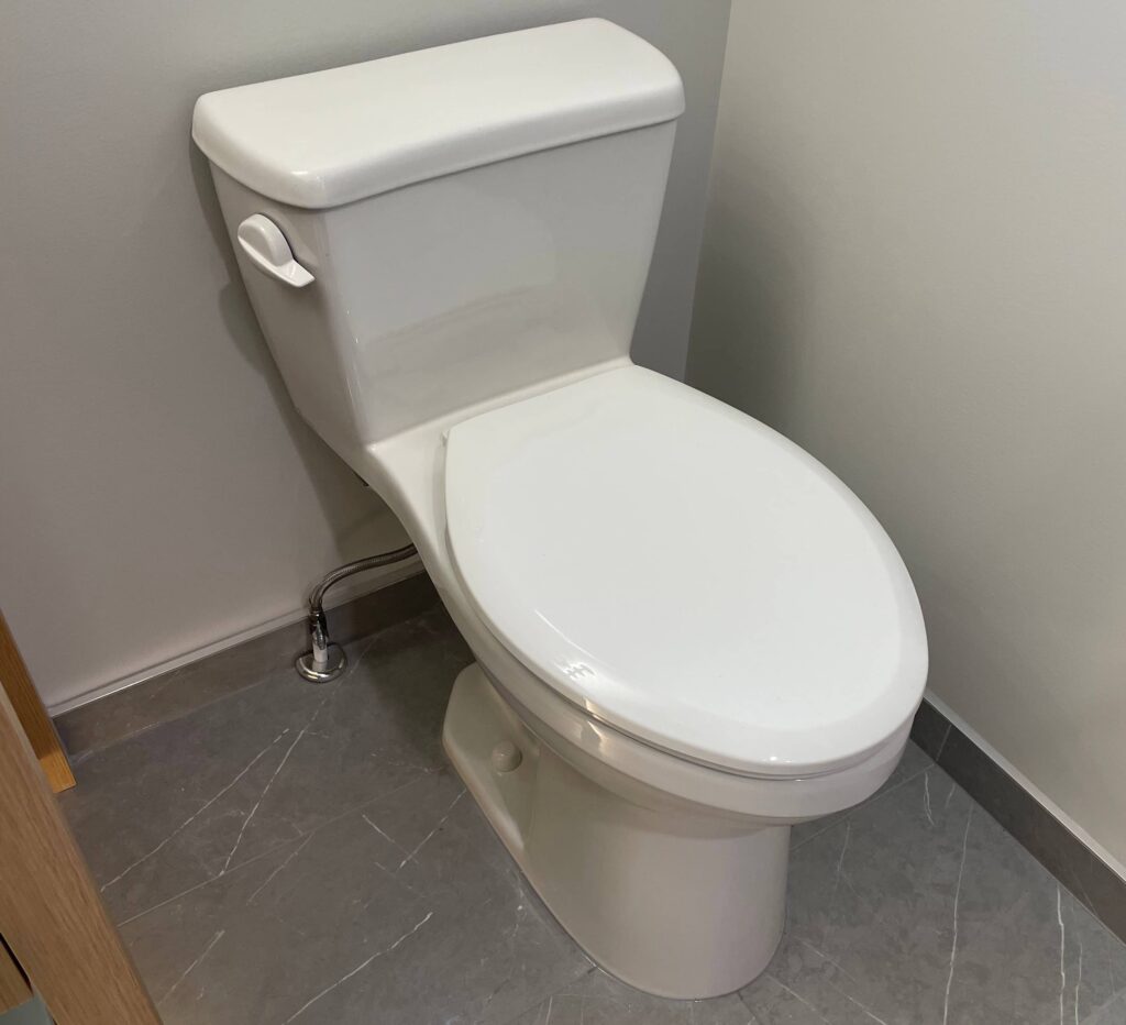 Standard white toilet installed and repaired by Kingdom Plumbing in Chilliwack, showcasing clean, modern bathroom fixtures.